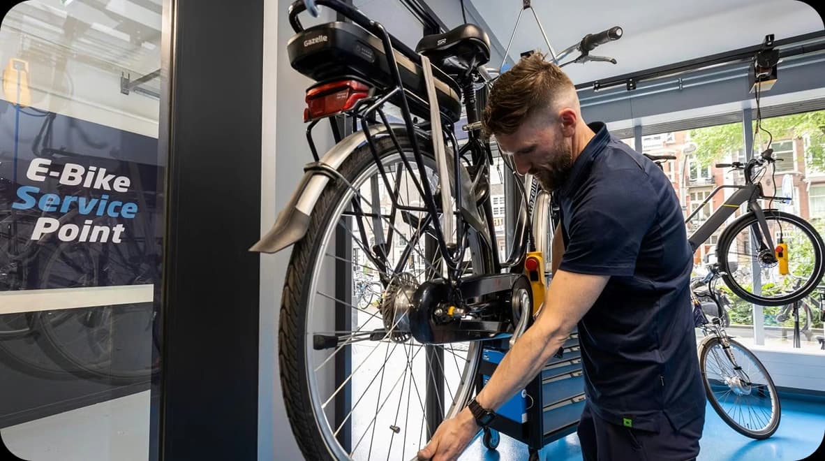Bike mechanic working on bicycle at service shop