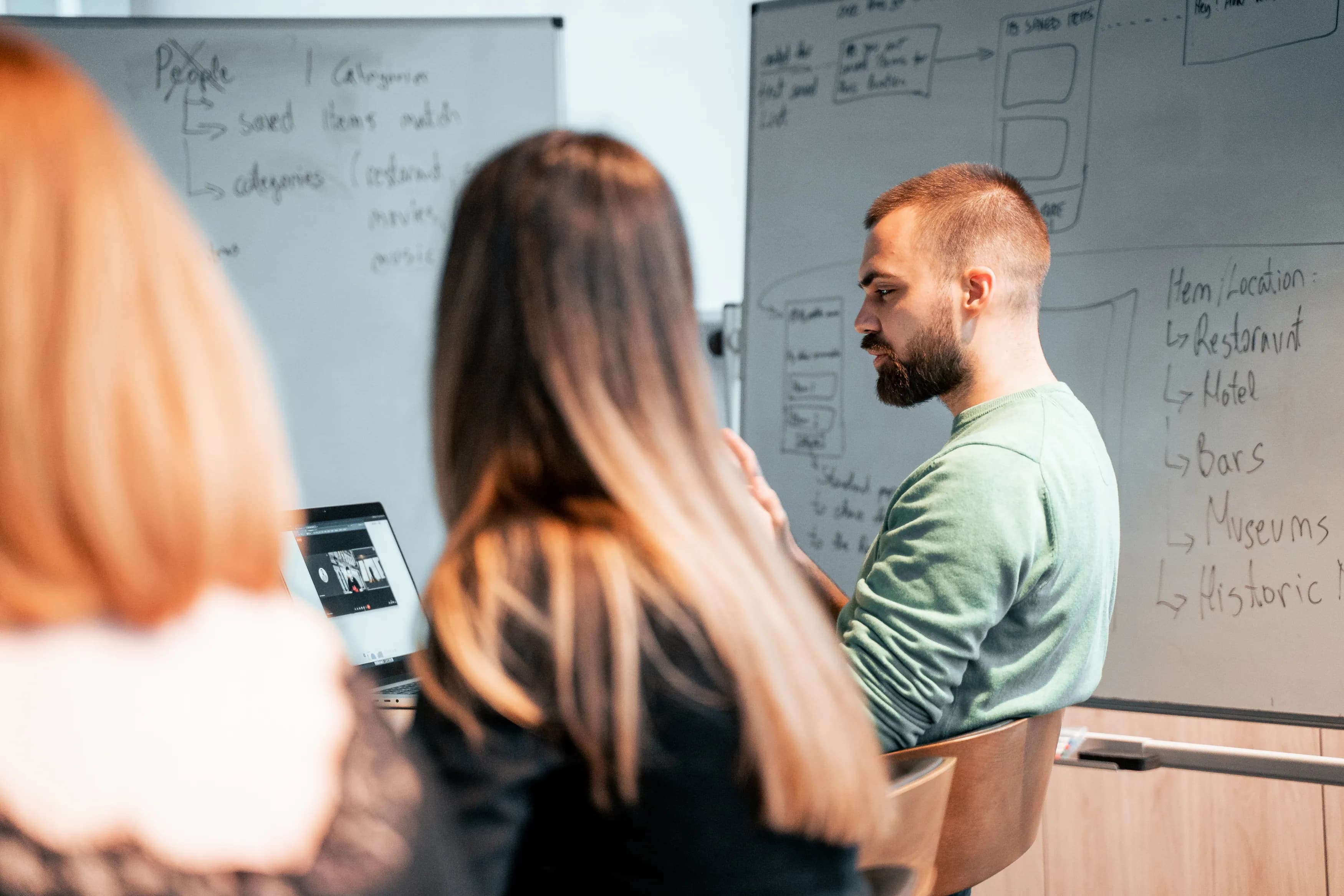 Product manager and designer collaborating during a client meeting at the Ministry of Programming office.